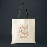 Roos Gold Modern Typography Wedding Maid of Honor Tote Bag<br><div class="desc">Chique Roos Goud Moderne Typografie en Achtergrondkleur! Kies een aangepaste kleur door te klikken op de link "verder aanpassen" onder de tekstaanpassingsgebieden. Scroll naar beneden aan de rechterkant van de editor voorbij de tekst en afbeeldingen en kies uit de kleuren of voer uw aangepaste kleurcode in! Stijlvolle Bruiloft Monogram Bruiloft...</div>