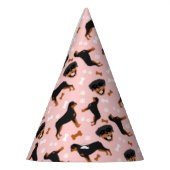 Rottweiler roteert roze meidenschilderpatroon feesthoedjes (Links)