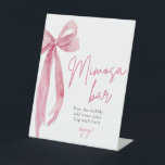 Roze boog Ze is het vastbinden van de knoop Mimosa Reclamebord Met Voetstuk<br><div class="desc">Welkom uw gasten op het vrijgezellenfeest met dit schattige mimosa barbord met de Pink Bow: She's Tying the Knot thema. Laat ze genieten van een heerlijke serie mimosas terwijl ze de aanstaande huwelijksvoltrekking van de bruid vieren. Met zijn charmante ontwerp en elegante roze boogaccenten zet dit bord de perfecte toon...</div>