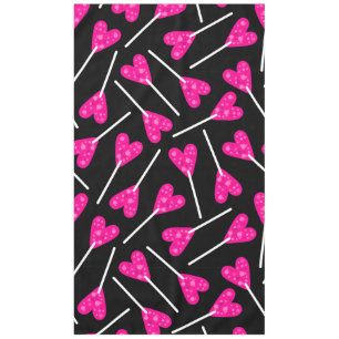 roze hartvormige lolly snoep zwart tafelkleed