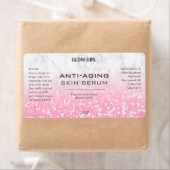 Roze kleurige glitter- en marmerserumetiketten etiket (Insitu)