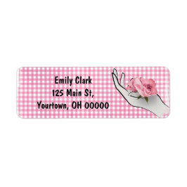 roze roos in hand op geruit etiket