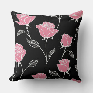 Roze rozen op zwart kussen