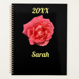 Roze rozenbloem op zwart minimalistisch gebruik planner