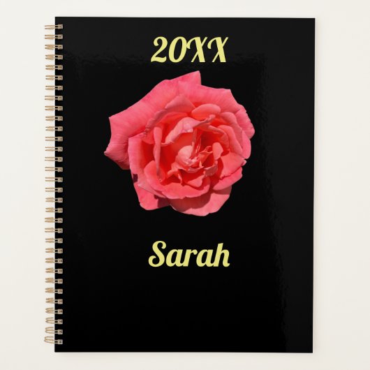 Roze rozenbloem op zwart minimalistisch gebruik planner (Voorkant)