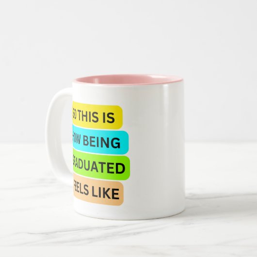 Roze tweekleurige mok SO_THIS_IS_HOW_BEING_GRADUAT (Voorkant links)