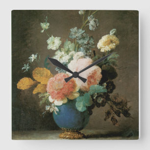 Rozen, Ranunculus en andere bloemen in een blauwe Vierkante Klok