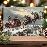 ruitenrenderslees feestdagen kaart<br><div class="desc">Retro Santa Claus Reindeer Slaaiholiday Kaart. Dit ontwerp is voorzien van de kerstman die zijn rendierslee door de nachtelijke hemel loodst. Wat een mooie retro vakantie scène. Pas dit douaneontwerp met uw eigen binnengroet aan.</div>