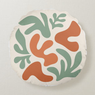 salie groene en terracotta abstracte wandkunst rond kussen