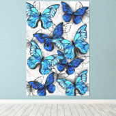 Samenstelling van witte en blauwe vlinders canvas afdruk (Insitu (Houten vloer))