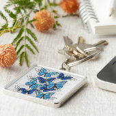 Samenstelling van witte en blauwe vlinders sleutelhanger (Zijkant)