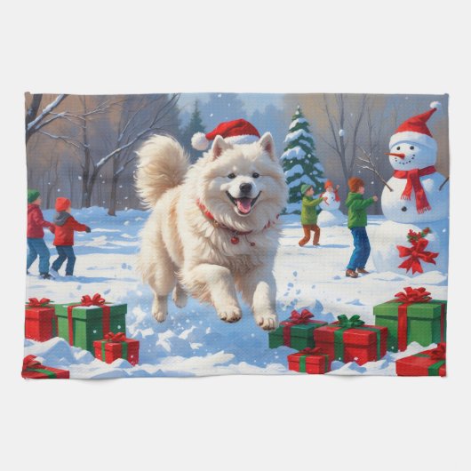 Samojed die in de sneeuw rent met een kerstmuts theedoek (Horizontaal)