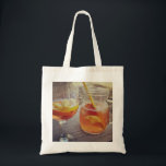 Sangria and Sunshine Tote Bag<br><div class="desc">This image shows a refreshing glass and pitcher of citrus sangria, perfect for a warm day. The fresh slices of lemon and orange add bright colour and hint of natural sweetness. One glass sits ready to enjoy while sangria is being poured from a small glass pitcher beside it, perfect for...</div>