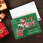 Santa Christmas Train Briefkaart<br><div class="desc">Dit oude beeld heeft een traditionele kerstman die langs een ouderwetse trein rijdt. Hij draagt snoepjes en brieven. De trein is rood en wit en de wielen zijn snoep van pepermuntzwaluw. Het woord Noel staat in de trein. De achtergrond is een diepe kerstgroen met een rode grens. Bekijk mijn winkel...</div>