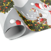 Santa claus and reindeer behind a christmas tree.j cadeaupapier (Rol Hoek)