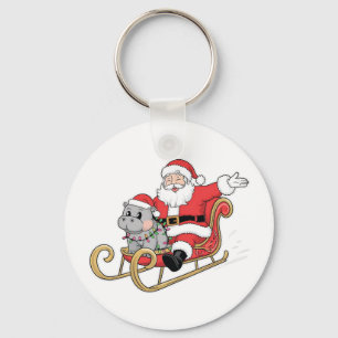 Santa Riding Sleigh met een Moo Deng Baby Hippo Sleutelhanger