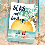 Santa Zeeen & Greetings Beach Game & Jokes Drieluik Wenskaart<br><div class="desc">Deel wat leuke en feestelijke groeten met deze drievoudige kerstkaart met een strandthematisch kerstwoord-zoekspel, grappen en een waterverf-kerstcape die kerstman, zeemeermin, walvis, schip en palmbomen omvat. De voorste bekleding is voorzien van een zeemeermin en de Kerstman (met een tropische anananastische drink) in de oceaan, een "Zeeen en groeten"-onderschrift in de...</div>