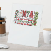 Santa's favoriete verpleegster, vrolijke verpleegs reclamebord met voetstuk (Insitu)