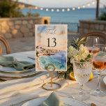 Santorini Wedding Table Numbers | Mediterranean  Kaart<br><div class="desc">Guide your guests in style with these elegant Santorini-inspired wedding table numbers, designed to complement a romantic Mediterranean destination wedding. Featuring a soft watercolor coastal scene with ocean blues and warm sunset tones, these table numbers add a refined and cohesive touch to your reception decor. The clean layout with bold...</div>