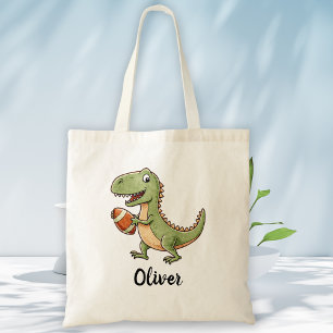 Schattige dinosaurus speelt voetbal tote bag