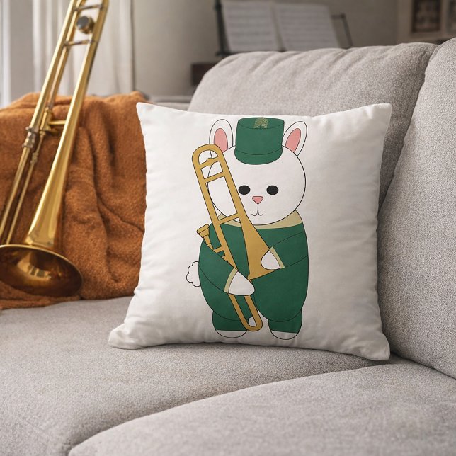 Schattige Marcherende Konijn Trombone Speler Carto Kussen (A throw pillow with a cute bunny holding a trombone in a green and gold marching band uniform.)
