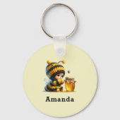 Schattige meisje in bijenkostuum met honing sleutelhanger (Voorkant)