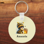 Schattige meisje in bijenkostuum met honing sleutelhanger (Voorkant)