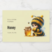 Schattige meisje in bijenkostuum met honing voedselcontainer etiket (Enkel label)
