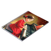 Schattige meisje in rode jurk die piano speelt notitieboek (Linkerzijde)