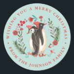 Schattige Penguin Christmas Holiday Name blauw Ronde Sticker<br><div class="desc">Schattige Handbeschilderde pinguïns met rood wit gestreepte wintergebreide petten op een blauwe achtergrond. Origineel kunstwerk van Caroline Bonne Müller</div>