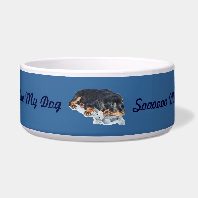 schattige rottweiler puppy dog snuffelend teddybee voerbakje (Voorkant)