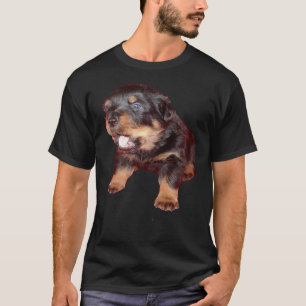 Schattige rottweiler-puppy met het laten vallen va t-shirt
