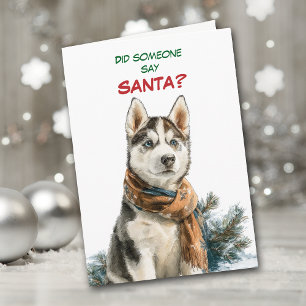Schattige Siberische Husky-hond zoekt naar Kerstma Feestdagen Kaart