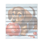Schattige teckel puppy spelen in de sneeuw notitieblok (Voorkant)