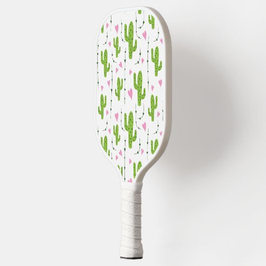 Schattigee cactus met harten in het groen pickleball paddle (Links)