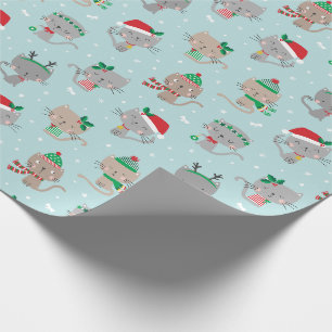 Schattigee kerstkatten op lichtblauw cadeaupapier