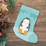 Schattigee Pinguïn op Ice Blue Winter Cartoon Naam Kleine Kerstsok<br><div class="desc">Deze schattige kerstkous is voorzien van schattige cartoon pinguïn met sneeuwval in pastel blauwgroen blauwe kleuren. Maakt een leuk vakantieaccent aan uw kerstdecor of een mooi cadeau voor kinderen en voor iedereen die van pinguïns en de winter houdt. · Personaliseer het met naam of pas het verder aan - bewerk...</div>