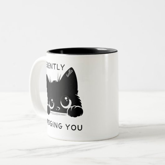 Schattigee zwarte kat oordeelt stilzwijgend over j tweekleurige koffiemok (Voorkant links)