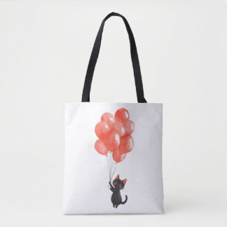 Schattigee zwarte kitten houdt een stel rode ballo tote bag
