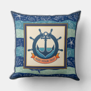 Scheepsanker en stuurwiel in marineblauw kussen