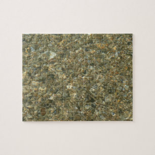 Schelpen onder rimpelend water legpuzzel