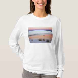 Schemerende lucht weerspiegeld in waterplas van t-shirt
