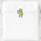 Schildpad die een bloem vasthoudt ronde sticker (Tas)