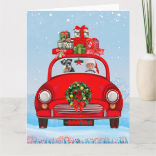 schnauzer Dog in auto met kerstman Kaart
