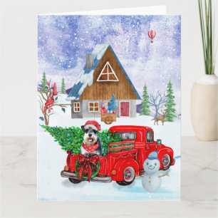 Schnauzerhond in kerstbezorgingswagen sneeuw kaart