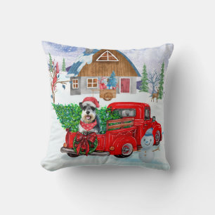 Schnauzerhond in kerstbezorgingswagen sneeuw kussen