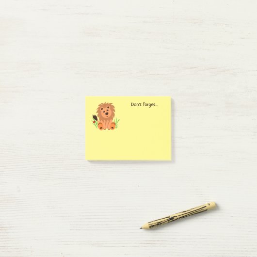 Schudde leeuw in het gras met ladybug post-it® notes (Op bureau)