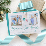 Seas and Greetings Seashell Ornament Holiday Photo Feestdagenkaart<br><div class="desc">Seas and Greetings Seashell Ornament Holiday Photo Christmas Cards featuring turquoise blue and sandy tan shell ornaments hanging from sailing jute rope with elegant typography. Add two of your foto's and a personal message for a fun nautical foliday card. Please contact us at cedarandstring@gmail.com if you need assistance with the...</div>