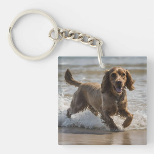 Seaside Fun: Cocker Spaniel bij Play in the Ocean Sleutelhanger