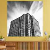 Shadows and Steel: The Silent Giant in the City Canvas Afdruk (Insitu (Woonkamer))